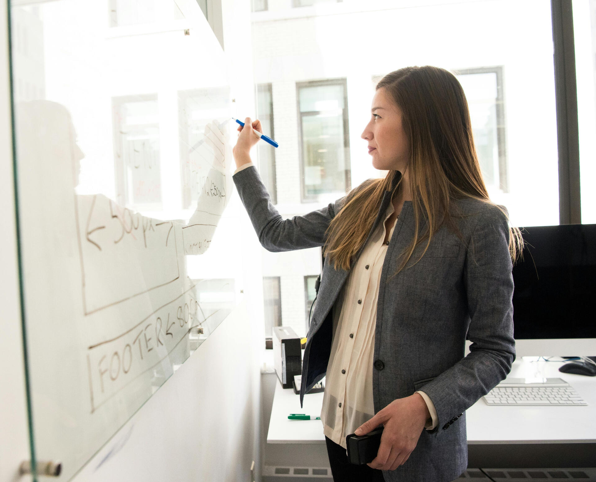 Image of woman in front of whiteboard